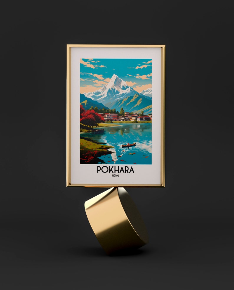 May include: A framed print of a vintage travel poster for Pokhara, Nepal. The poster features a colourful illustration of a mountain range, a lake, and a small village. The text "Pokhara, Nepal" is printed in white at the bottom of the poster.