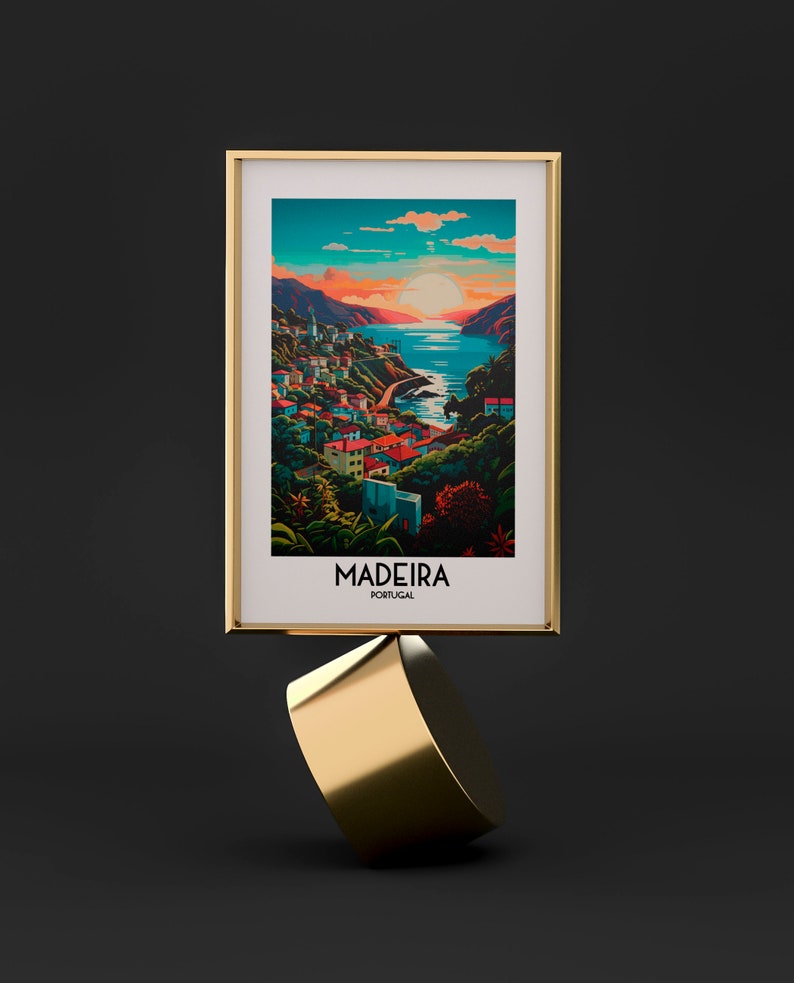 May include: A framed print of a colorful illustration of a coastal town in Madeira, Portugal. The print features a sunset over the ocean with a town built on a hillside. The text "MADEIRA PORTUGAL" is printed below the illustration.