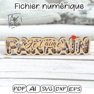Puede incluir: Letrero de madera clara con las palabras "PARRAIN Je t'aime" recortadas, con engranajes y un corazón rojo. El texto "Fichier numérique" está en la parte superior. El logo "Art & Graph" es visible.