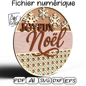 May include: Circular wooden Christmas decoration with the words "JOYEUX Noël" in brown script. The design includes snowflakes, a woven pattern, and the text "Fichier numérique". The image also shows the file types: PDF, AI, SVG, DXF, and EPS.