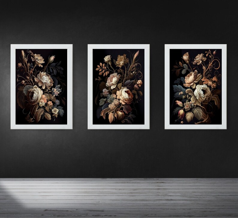 May include: Three framed floral art prints. Each print features a bouquet of flowers in shades of cream, brown, and green against a dark background. The frames are white, and the artwork is displayed on a dark gray wall.
