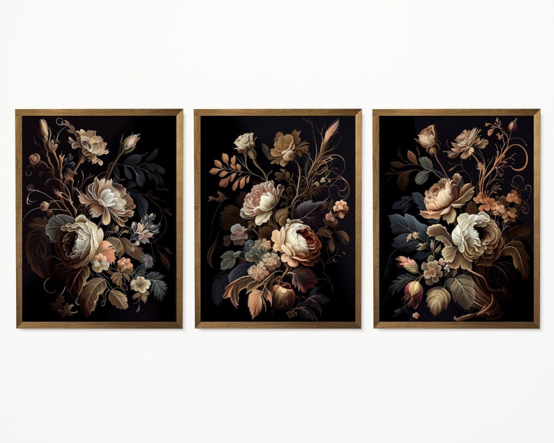 May include: Set of three framed floral art prints. Each print features a detailed illustration of a bouquet of flowers in shades of cream, brown, and peach against a black background. The frames are a warm brown color.