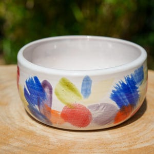 Multicolored stoneware ceramic bowl. Colorful decorative ceramic bowl. Ceramic plate for decoration.
