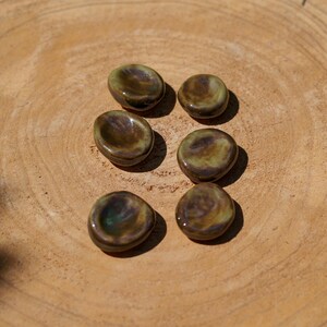 Green-brown ceramic Worry Stone. Shiny anti-stress pebbles. Ceramic relaxation stone. Green ceramic calming stones.