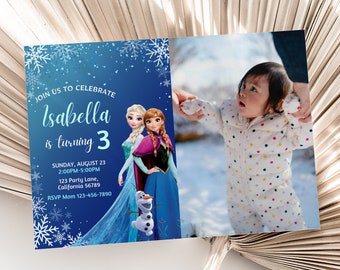 May include: A blue and white birthday invitation featuring a picture of two girls dressed as Elsa and Anna from Frozen. The invitation reads "Join us to celebrate Isabella is turning 3" and includes the date, time, and location of the party.