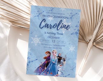 May include: A blue invitation card with a snowflake design. The card features a picture of the characters from the movie Frozen, including Elsa, Anna, Olaf, and Kristoff. The text on the card reads "Join us for a magical Frozen celebration. Caroline is turning three. December 12. Saturday at 4 PM. 123 Party Lane, California 56789. RSVP to Mom 123 456 7890."