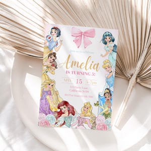 May include: A party invitation featuring illustrations of various princesses. The invitation has a pink bow at the top and text that reads "Join us to celebrate Amelia IS TURNING 5!" with the date and time. The invitation is on a white background.