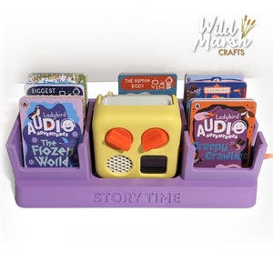 May include: Purple story time organiser with a yellow toy radio and a variety of children's books. The books include titles like "The Frozen World" and "Creepy Crawlies".
