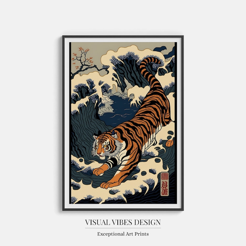 May include: A black framed print of a tiger walking through a wave. The tiger is orange and black with white stripes. The wave is blue and white. The background is a light beige colour. The print has the text "VISUAL VIBES DESIGN" and "Exceptional Art Prints" at the bottom.