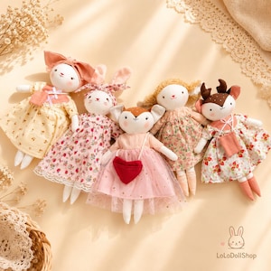 May include: Five plush dolls featuring animal faces, including rabbits and a deer, dressed in floral and patterned dresses. One doll wears a pink tulle skirt with a red heart-shaped bag. The text LoLoDollShop is visible in the bottom right corner.