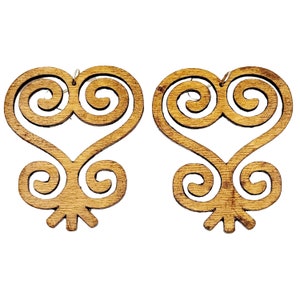 May include: A pair of wooden earrings in the shape of the Adinkra symbol Sankofa, which represents the importance of learning from the past. The earrings are brown and have a detailed design.