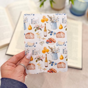 May include: A rectangular card featuring a repeating watercolor pattern of yellow pears, orange slices, blue pitchers with flowers, wine bottles, glasses of white wine, slices of bread, wedges of cheese, and small blue berries on a white background.