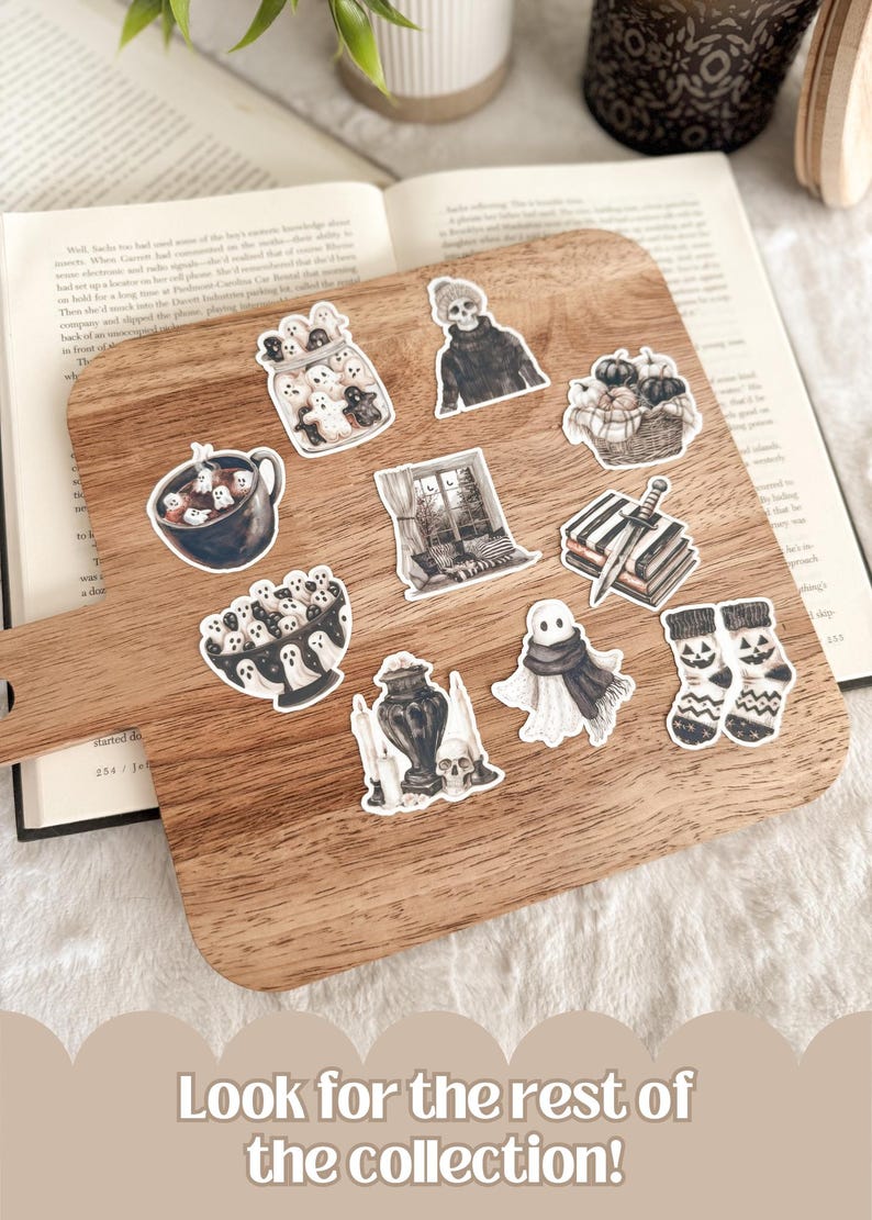 May include: A wooden cutting board displays a collection of Halloween-themed stickers. The stickers feature ghosts, pumpkins, a skull, and other spooky illustrations. The text at the bottom says, "Look for the rest of the collection!"