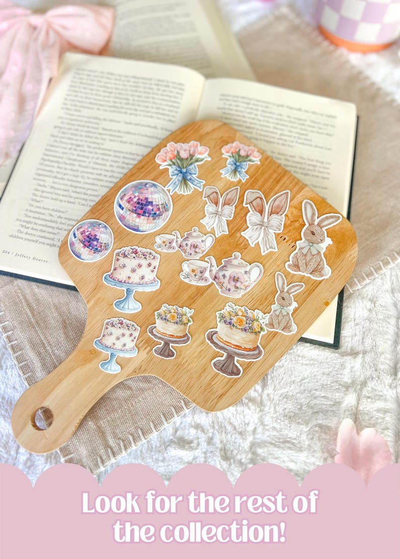 May include: A wooden cutting board with a variety of stickers on it. The stickers feature images of cakes, teacups, bunnies, and bouquets of flowers. The text "Look for the rest of the collection!" is printed on a pink background below the cutting board.