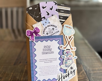 May include: A wrapped gift with a "Spicy Hockey Romance" label, featuring stickers of hockey sticks, a snowman, and a coffee cup. The gift includes cards with hockey and shoe designs, and a purple bow.