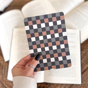 May include: A rectangular card featuring a repeating checkered pattern in alternating shades of white, dark gray, and muted terracotta. The card has rounded corners and a smooth, flat surface, displaying a consistent grid design across its entire front.