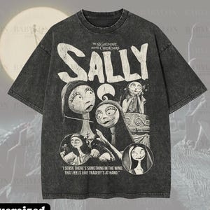 May include: A dark gray oversized t-shirt featuring a graphic of Sally from "The Nightmare Before Christmas." The design includes the character's name and several illustrations of Sally. The shirt also has the text "I sense there's something in the wind, that feels like tragedy's at hand."