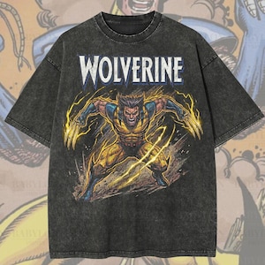 May include: A dark grey oversized t-shirt with the word "WOLVERINE" in white. Below is a graphic of the character in yellow and blue, with yellow energy effects. The shirt has the text "Oversized Premium Tee!" and "Original Artist of This Design".