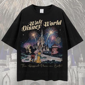 May include: Black oversized t-shirt featuring a colorful graphic of Walt Disney World with Mickey Mouse and Pluto. The design includes fireworks, a castle, and the text "The Happiest Place on Earth!"