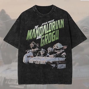 May include: Black oversized t-shirt with the words "The Mandalorian and Grogu" in green, and an image of Grogu and other characters. The tee has a distressed, vintage appearance.