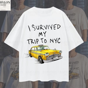 May include: White t-shirt featuring a yellow taxi cab graphic and the text "I survived my trip to NYC".