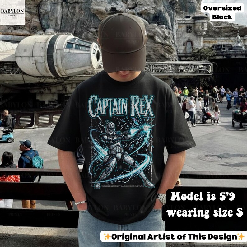 May include: Black oversized t-shirt with a Captain Rex graphic and blue lightning. The text "CAPTAIN REX" is in a stylized font. The model is 5'9" and wearing size S. The design is by the original artist.