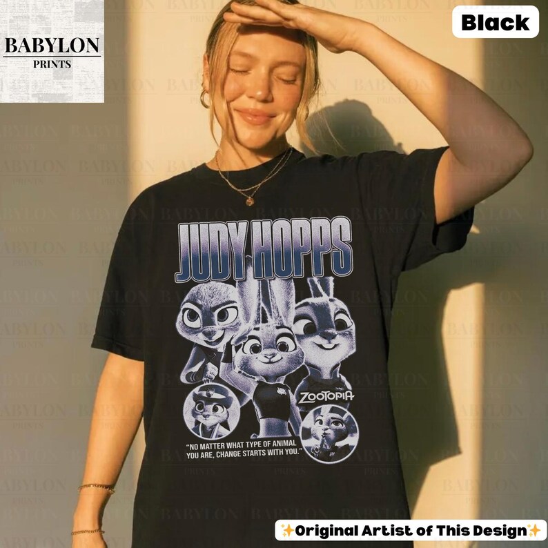 May include: Black t-shirt featuring the text "JUDY HOPPS" above a graphic of characters from the movie Zootopia. The shirt also includes the quote "NO MATTER WHAT TYPE OF ANIMAL YOU ARE, CHANGE STARTS WITH YOU."