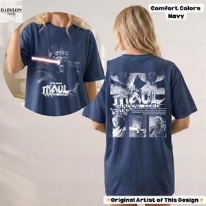 May include: Navy blue t-shirt featuring a graphic of Darth Maul with the text "STAR WARS MAUL SHADOW LORD". The back of the shirt has a matching design with additional text and images. The shirt is a comfort colors style.