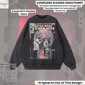 May include: Black oversized washed sweatshirt featuring a vintage Star Wars comic book cover design. The graphic includes the text "STAR WARS A NEW HOPE" and images of characters. The sweatshirt has a crew neck and long sleeves. The size chart is in inches.