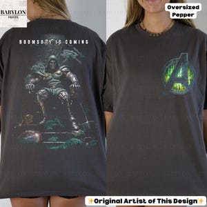 May include: Dark gray oversized t-shirt with a graphic of a seated armored figure and the text "DOOMSDAY IS COMING" on the back. The front features the Avengers logo. The shirt is labeled "Oversized Pepper".