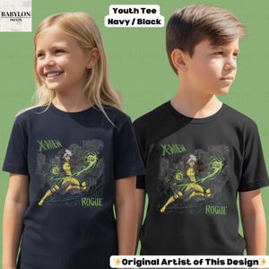 May include: Two children's t-shirts, navy and black, displaying a Rogue graphic from X-Men. The design incorporates the text "X-Men" and "Rogue" in green. The shirts are labelled "Youth Tee Navy / Black".