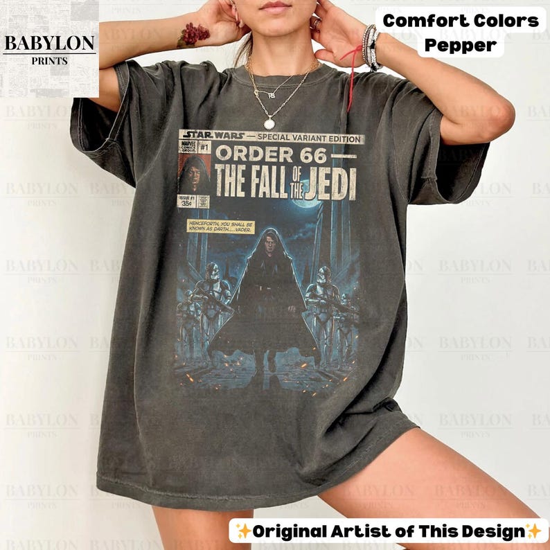 May include: Dark grey t-shirt featuring a Star Wars comic book cover design. The graphic includes the text "STAR WARS - SPECIAL VARIANT EDITION ORDER 66 - THE FALL OF THE JEDI." The shirt is a Comfort Colors Pepper tee.