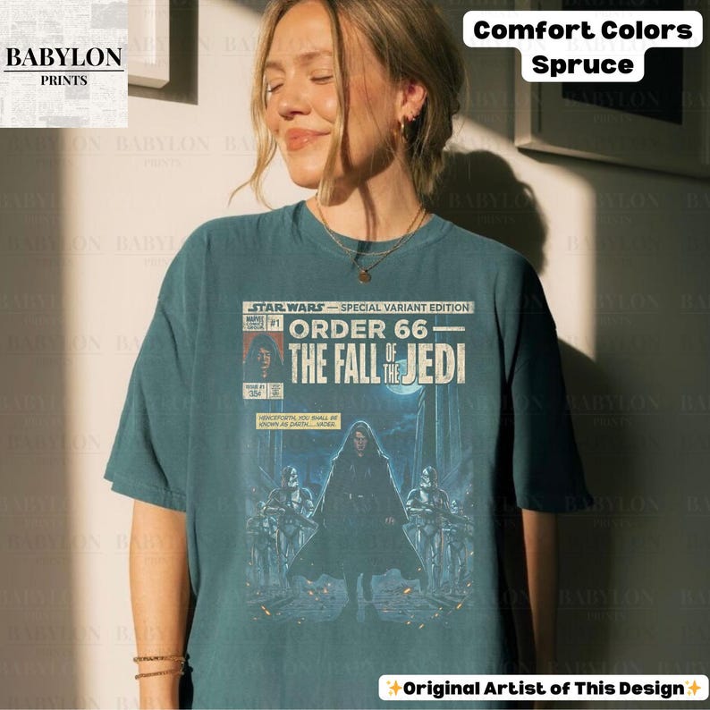 May include: A teal-colored t-shirt featuring a Star Wars comic book cover design. The graphic includes the text "STAR WARS - SPECIAL VARIANT EDITION" and "ORDER 66 - THE FALL OF THE JEDI." The shirt also has the text "Comfort Colors Spruce" and "Original Artist of This Design."