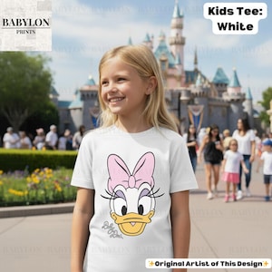 May include: White kids' tee featuring a Daisy Duck graphic with a pink bow and eyelashes. The shirt has the text "Kids Tee: White" at the top. The design is from the "Original Artist of This Design".