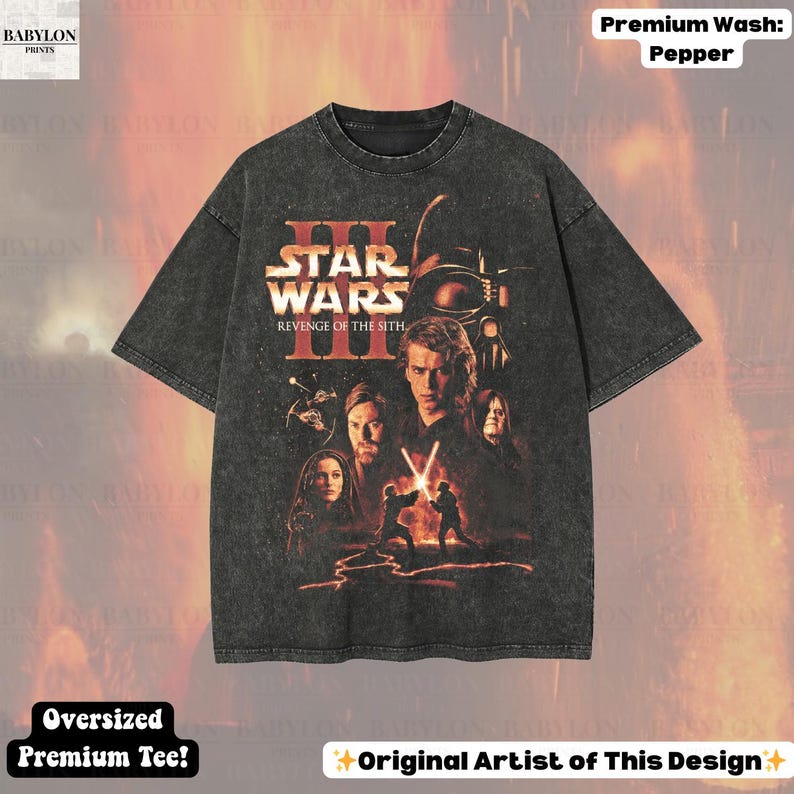 May include: A dark gray oversized t-shirt featuring a Star Wars: Revenge of the Sith graphic. The design includes characters and the film's title. The shirt has a premium wash and is labeled as an oversized premium tee.