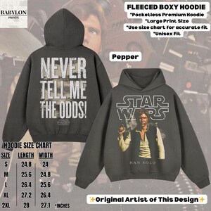 Puede incluir: Sudadera con capucha unisex de Star Wars color pimienta con un gr&aacute;fico de Han Solo y el logo de Star Wars en la parte delantera. La parte trasera de la sudadera tiene el texto "NEVER TELL ME THE ODDS!".