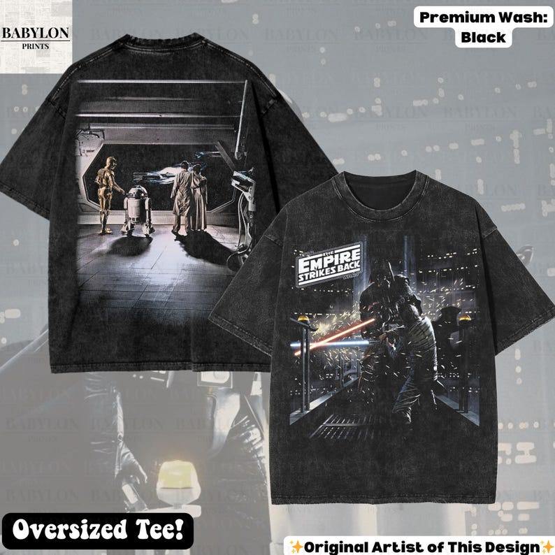 May include: Black oversized tee featuring scenes from "Star Wars: The Empire Strikes Back." The front displays a battle scene with the text "Empire Strikes Back." The back shows C-3PO, R2-D2, and others. The shirt has a premium wash.