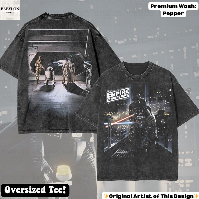 May include: Pepper-washed, oversized tee featuring Star Wars scenes. The front displays Darth Vader in a lightsaber duel, while the back shows C-3PO, R2-D2, and others. The shirt includes the text "EMPIRE STRIKES BACK" and "Original Artist of This Design".