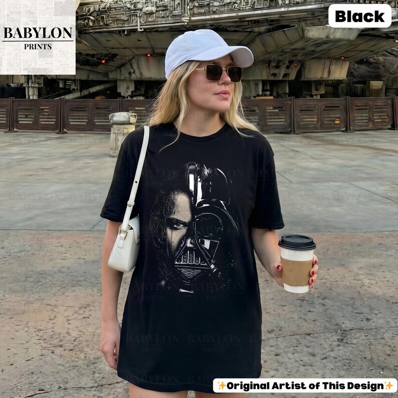 May include: A white ceramic mug with a black handle and the text "But First, Coffee" in a bold, black font. The mug is set against a blurred background, suggesting a cozy setting.