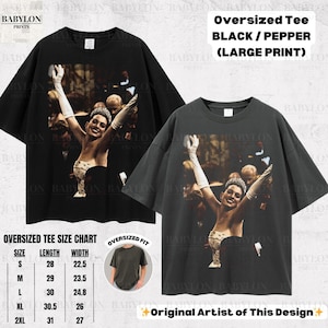 May include: Two oversized black and pepper-coloured t-shirts with a large print of a woman in a gown with her arms raised. The shirts have the text "Oversized Tee BLACK / PEPPER (LARGE PRINT)". A size chart is also included.