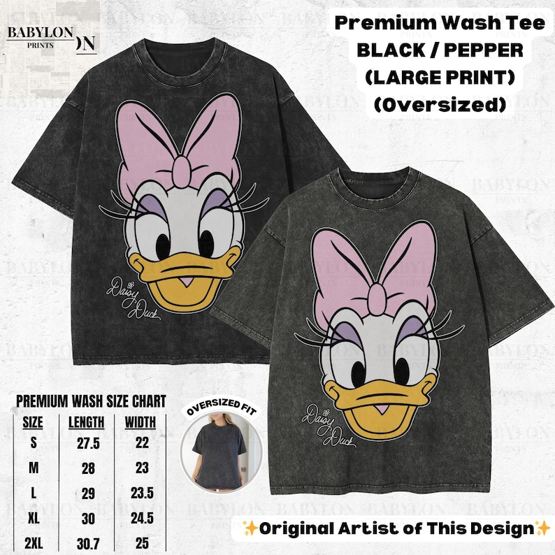 May include: Two black oversized t-shirts with a large Daisy Duck graphic. The graphic features Daisy's face with a pink bow, white face, and yellow beak. The shirts have a premium wash and are available in sizes S to 2XL.