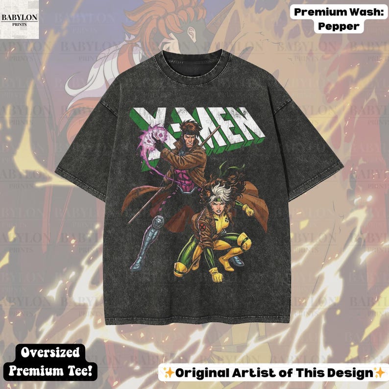 May include: A dark gray oversized premium tee featuring the X-Men logo and comic book art of Gambit and Rogue. The shirt has the text "Oversized Premium Tee!" and "Original Artist of This Design". The shirt is made of a soft, comfortable material.
