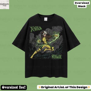 May include: Black oversized t-shirt with a Rogue graphic from X-Men. The design includes the text "X-MEN" in green and "ROGUE" in white. The character is in a yellow and green costume, with green energy effects.