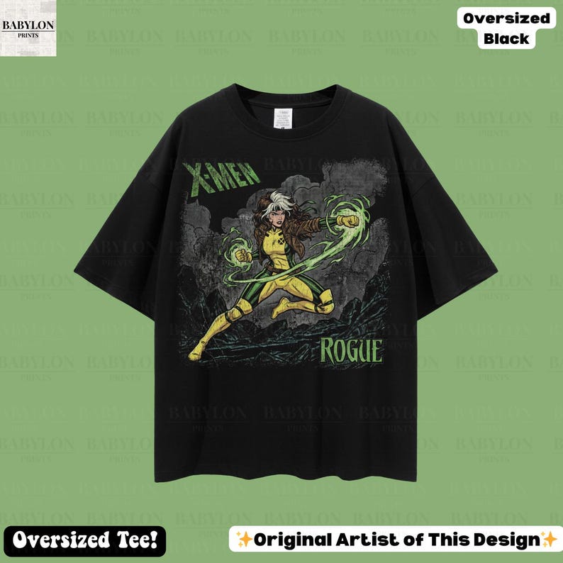 May include: Black oversized t-shirt with a Rogue graphic from X-Men. The design includes the text "X-MEN" in green and "ROGUE" in white. The character is in a yellow and green costume, with green energy effects.