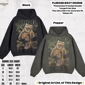 May include: Black and pepper-colored fleece boxy hoodies featuring a Star Wars graphic with an Ewok character. The hoodies have a large print size and are available in unisex sizes. The size chart shows lengths from 24.8 to 28 inches and widths from 24 to 27.1 inches.