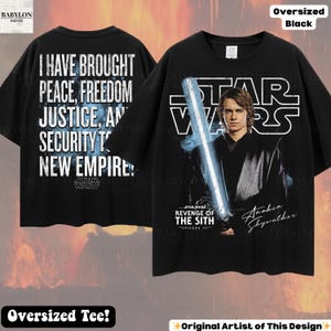 May include: Black oversized t-shirt featuring Anakin Skywalker from Star Wars: Revenge of the Sith. The front displays Anakin with a lightsaber and the Star Wars logo. The back has the text: "I HAVE BROUGHT PEACE, FREEDOM, JUSTICE, AND SECURITY TO NEW EMPIRE!"