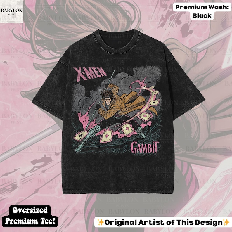 May include: Black oversized premium tee featuring a graphic of the X-Men character Gambit. The design includes the text "X-Men" and "Gambit" in pink and white. The shirt has a vintage wash and the text "Original Artist of This Design".
