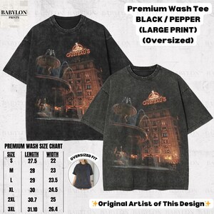 May include: Black oversized t-shirts with a large print of a fountain and building, with the text "GUSTEAU'S". The shirts are part of the "Premium Wash Tee" collection. The size chart shows lengths from 69.85 to 79 cm and widths from 55.88 to 67.06 cm.