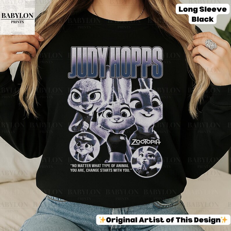 May include: Black long-sleeve shirt featuring a graphic of Judy Hopps from Zootopia. The design includes the text "JUDY HOPPS" and the quote "NO MATTER WHAT TYPE OF ANIMAL YOU ARE, CHANGE STARTS WITH YOU."