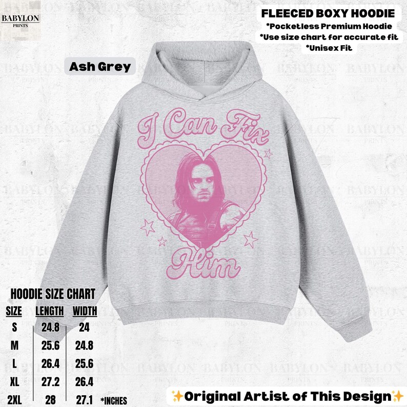 May include: Ash grey fleece boxy hoodie with a pink graphic of a man inside a heart with the text "I Can Fix Him". The hoodie has a hood and a size chart. Unisex fit. Made of a soft material.